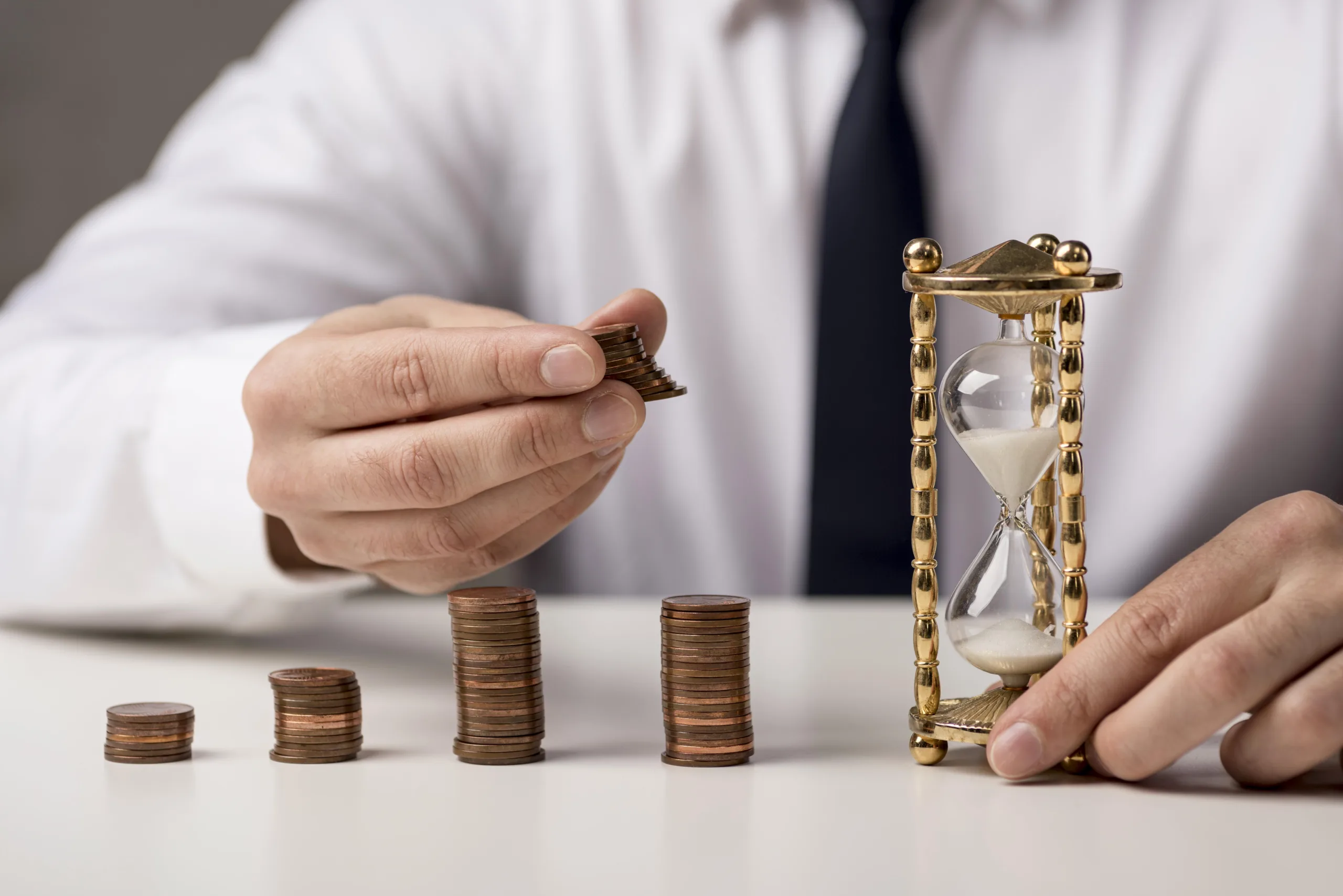 front-view-businessman-with-coins-hourglass